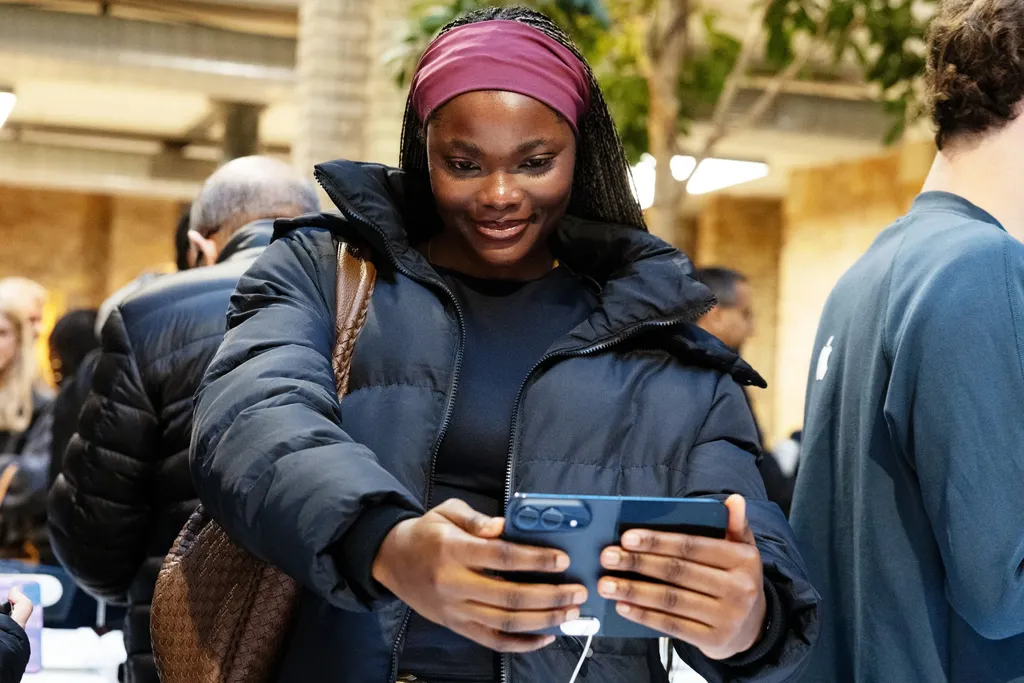 A customer tries the iPhone Duo at Apple Covent Garden in London on launch day
